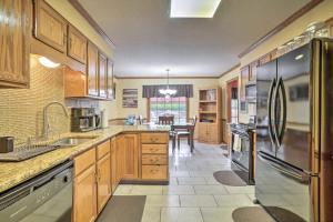 a kitchen with wooden cabinets and stainless steel appliances at Comfortable and Pleasant 4 Bedroom Home in Memphis