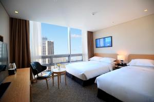 Postel nebo postele na pokoji v ubytování Best Western Haeundae Hotel