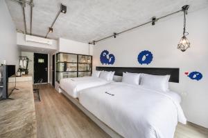 a bedroom with two large white beds in it at Kokotel Khao Lak Lighthouse in Khao Lak