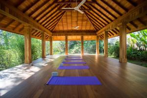 a yoga pavilion with purple mats on the floor at Rukgala Retreat in Digana