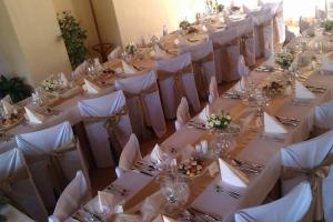 a row of tables with white table linens at Hotel Rudka in Kunštát