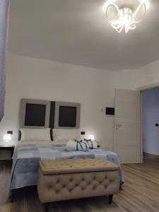 a bedroom with a large bed with a blue comforter at B&B Capovento Della Murgia in Altamura