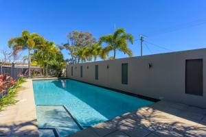 a swimming pool in the backyard of a house at Rainbow Surf 5 in Rainbow Beach