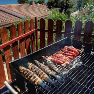 a bunch of sausages and other food on a grill at VistaMare in Villaputzu
