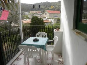 a table and chairs on a balcony with a view at Novecento in Lipari