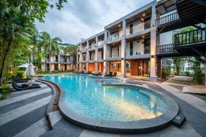 a large swimming pool in front of a building at Kokotel Khao Lak Lighthouse in Khao Lak