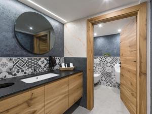 a bathroom with a sink and a mirror at Garni Nill in Schwendau