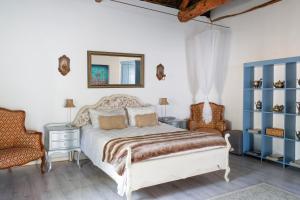 a bedroom with a bed and a mirror and a chair at Green Gables Country Inn in McGregor