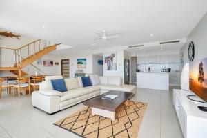 a living room with a couch and a table at Rainbow Sea Resort in Rainbow Beach