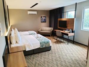 a hotel room with a bed and a desk at NB HOTEL in Johor Bahru