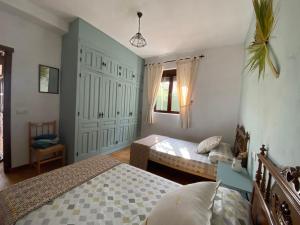 a bedroom with two beds and a window at Maison écologique avec piscine in La Puerta de Segura +14 photos