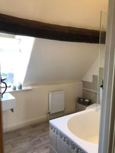 a bathroom with a tub and a window at Little Gem on Bridgnorth's Cartway. River Views in Bridgnorth