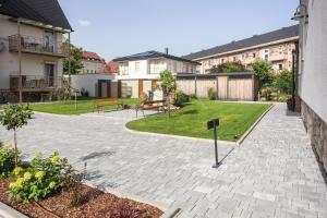 a courtyard with a bench and a yard with houses at Apart of me Villach in Villach