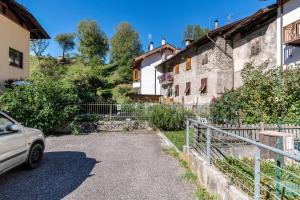 a car parked in front of a house at Appartamento Al Sasso Rosso Dimaro in Dimaro