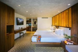 ダナンにあるLIVIE Da Nang Styleの大きなベッドとキッチンが備わるホテルルームです。
