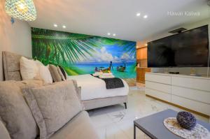 a bedroom with a mural of a beach at Yalarent Hawaii Complex Boutique & Garden Hotel Apartments Eilat in Eilat