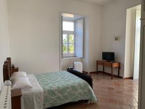 Un pat sau paturi într-o cameră la Guest house Il Palazzo Marchesale