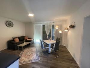 a living room with a table and a couch at Sorinas Home - Comfortable Apartment near Graz - Free Parking in Wagersbach