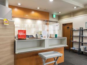 a pharmacyacist with a bench and a book shelf at Tabist HotelArflex Tokuyama Station in Shunan