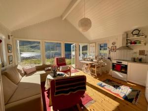 a living room with a couch and a table at Mountain Panorama in Bøstad