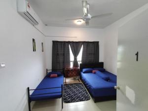 1 dormitorio con 2 camas y ventana en Melinjau Homestay Putrajaya for Islamic Friendly, en Putrajaya