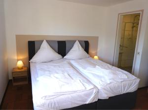 Ένα ή περισσότερα κρεβάτια σε δωμάτιο στο Dreikausens Landgasthaus Wildhof