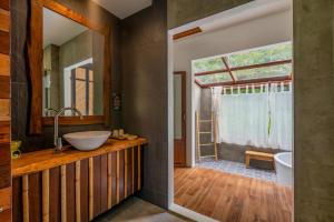 a bathroom with a sink and a mirror at Ban Sainai Resort- SHA Extra Plus Aonang's Green Resort in Ao Nang Beach