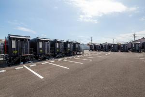 a row of train cars parked in a parking lot at HOTEL R9 The Yard Ube in Ube