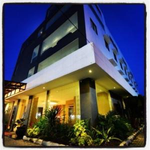 a large building with a lit up facade at night at Anaya Hotel and Ballroom in Medan