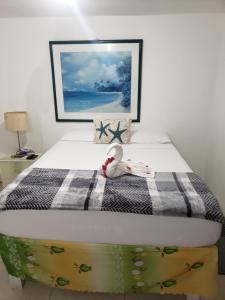 a bed with a stuffed animal sitting on top of it at Grace Garden Guesthouse in Ocho Rios