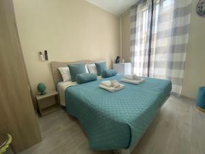 a bedroom with a bed with two towels on it at Si Viaggiare Apartments in Partinico