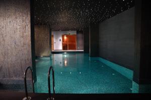 a swimming pool with a blue tile floor and stairs at Galata's Hotel in Istanbul