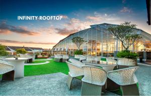 a view of a building with tables and chairs at Infinity8 Bali in Jimbaran