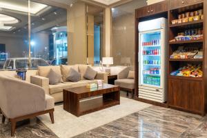a living room with a couch and a refrigerator at فخامة الضيافة - Dyafa Luxury in Al Khobar