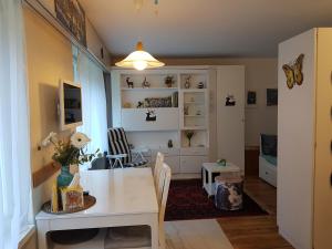 a kitchen and dining room with a white table and chairs at Seegarten B (168 Be) in Lenzerheide