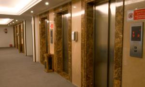 a hallway in a building with gold marble walls at Al Massa Grand Hotel in Mecca