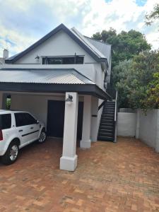 a white car parked in front of a house at Thornley Studio in Knysna