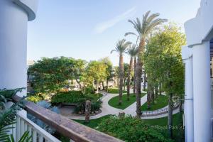 a balcony view of a park with palm trees at YalaRent Royal Park Resort Complex Apartments in Eilat