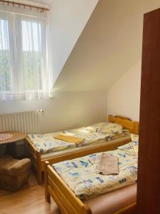 a room with three beds and a table at Zajazd pod Sosnami in Berezka +11 photos