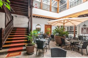 a restaurant with tables and chairs and a staircase at Isla Baja Suites in Garachico