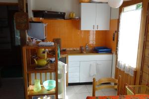 a small kitchen with a sink and a counter at Le Clos du Vas - Puy Saint André in Puy-Saint-André