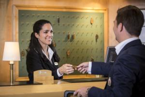 a woman is handing a man a gold ring at Crystal Plaza Hotel in Stockholm