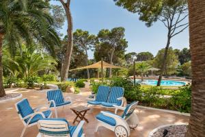 a patio with chairs and a swimming pool at Villa Claramunda in Cala D'or