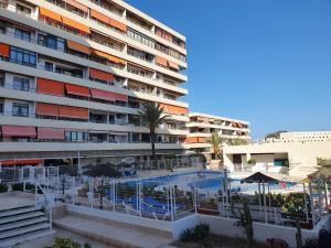 a hotel with a swimming pool in front of a building at Nogalera Sea&Sun Apartment in Torremolinos