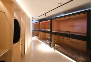 a room with many closets with lights in it at SLEEEP JP Fujinomiya in Fujinomiya