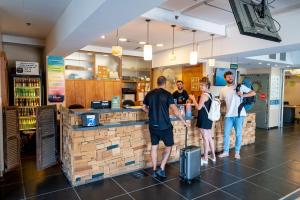 a group of people standing at a counter in a store at Abraham Tel Aviv in Tel Aviv