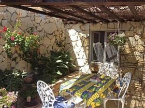 un patio con mesa, 2 sillas y una mesa en Stunning Cottage with Pool in Provence France, en Lorgues