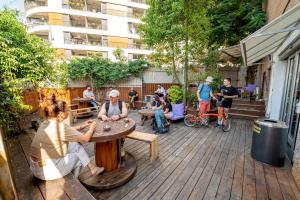 a group of people sitting at a table on a deck at Abraham Tel Aviv in Tel Aviv
