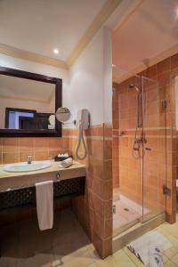 a bathroom with a sink and a shower at Grand Mogador Agdal & Spa in Marrakech