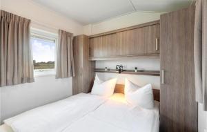 una camera da letto con un letto con lenzuola bianche e una finestra di 2 Bedroom Stunning Home In Ssel a Süsel